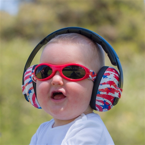 Baby with sound reducing headphones